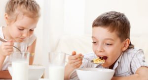 kids eating cereal and drinking milk