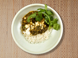 panaak paneer Indian recipe of spinach gravy with cottage cheese over steamed rice