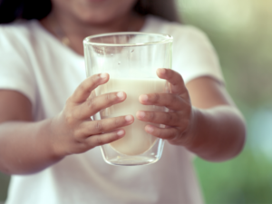 photo of hung girl holding a nutritious glass of milk