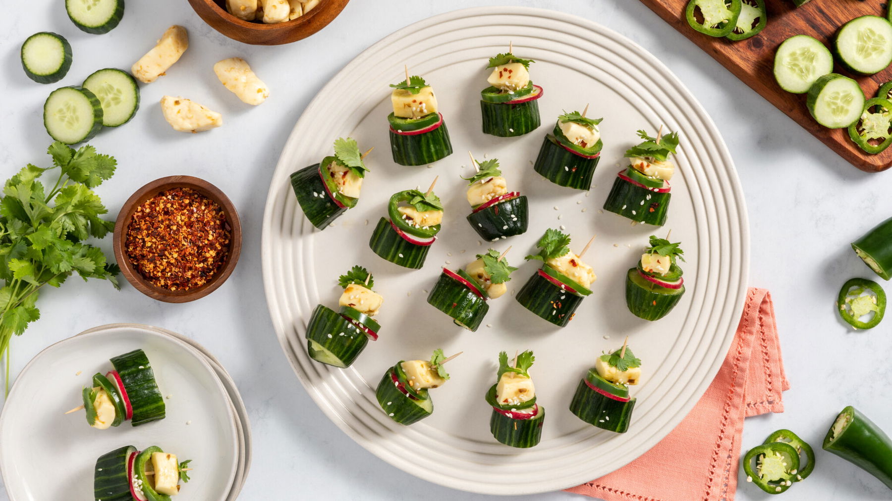 skewered appetizer with Asian marinated cucumber, radish, and jalapeno slices and jalapeno cheese curds